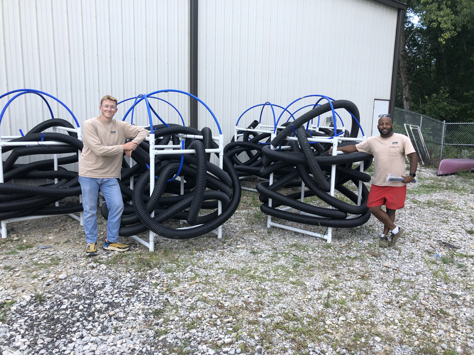 Staff standing with some of the artificial fish habitat structures named Hoosier Cubes.